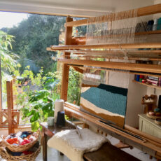Weaving on the upright loom in Debbie's Falmouth Textile Studio.
